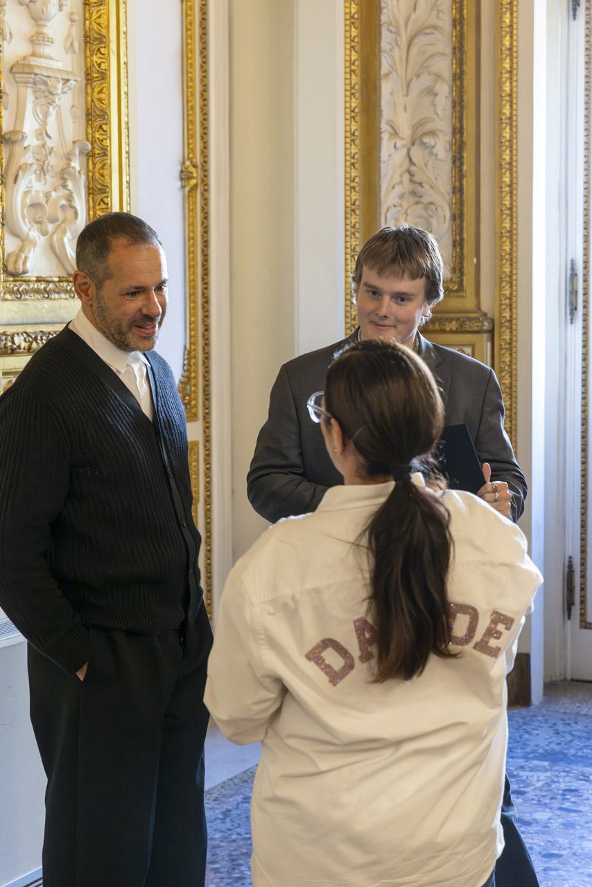 Carter Mills, with Polimoda Director Massimiliano Giornetti, meets Davide Renne's family at the Davide Renne Scholarship award ceremony. Photo by Riccardo Bartalucci.