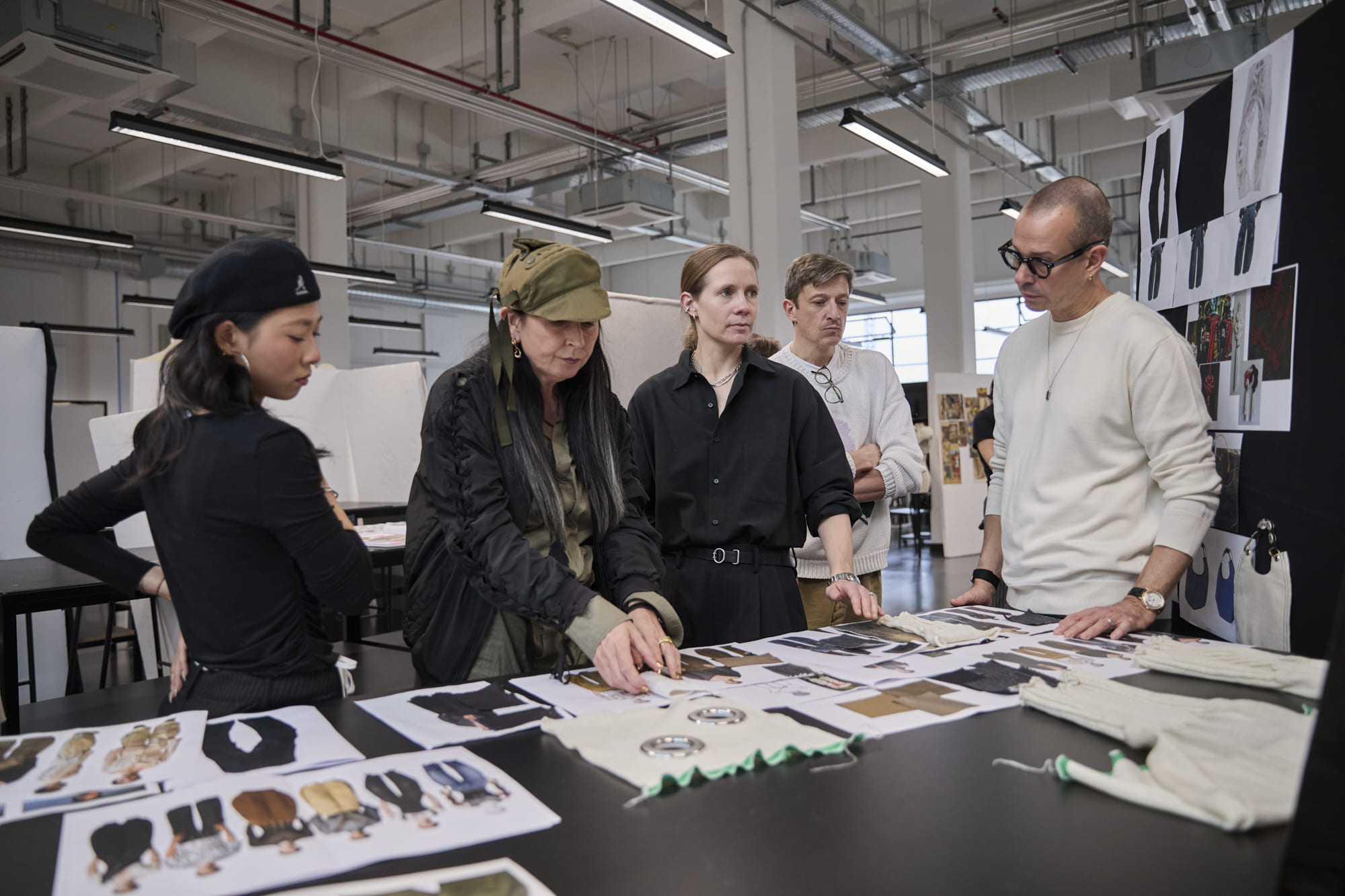 Luke Meier, Lucie Meier, An Vandevorst, and Maxence Dinant reviewing student collections at Polimoda’s Manifattura Campus.