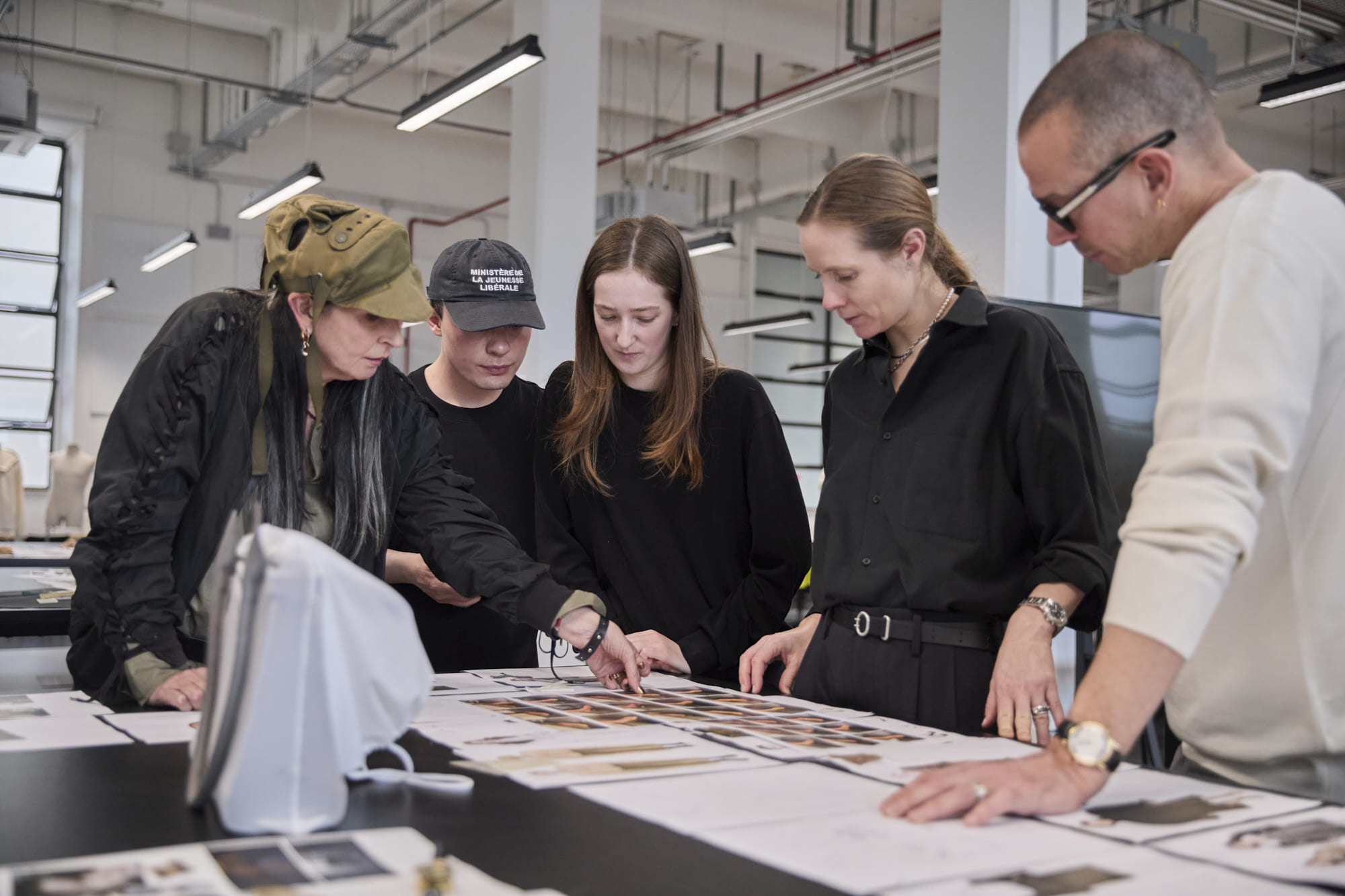 Luke Meier, Lucie Meier, and An Vandevorst reviewing a Fashion Design student’s moodboard at Polimoda’s Manifattura Campus.